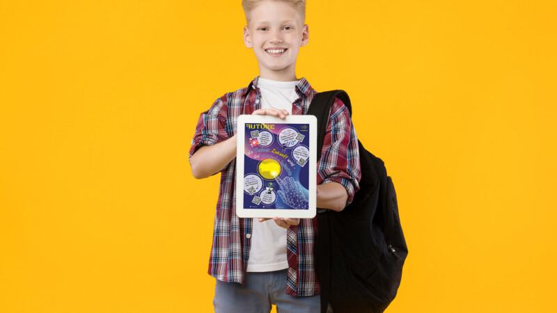 Happy Blonde Schoolboy Holding Tablet, Showing Black Display For Mock Up, Orange Studio Wall